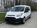 2016 Ford Transit Connect with a white exterior and black accents parked on a street