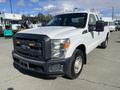 A 2013 Ford F-250 SD pickup truck with a white exterior and a black grille featuring LED lights in the front