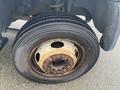 Close-up of a used tire on a 2008 Dodge Ram 5500 showing visible wear and rust on the wheel rim and lug nuts