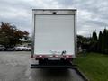 A 2018 Hino 195 box truck viewed from the rear with a plain white cargo area and rear lights visible