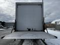 A 2019 Hino 338 truck with a 24-foot cube cargo area and a lowered liftgate at the rear