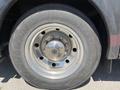 A close-up view of the front wheel of a 2008 Newmar Canyon Star 36 Foot Class A Motorhome showing a shiny metal rim and a tire with visible tread patterns