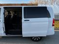 A white 2022 Mercedes-Benz Metris with an open sliding side door revealing the interior seating and wooden cargo stacked on the roof