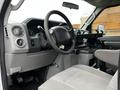 Interior view of a 2009 Ford Econoline showing the steering wheel dashboard and driver seat with gray upholstery