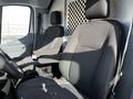 Two black fabric seats with striped accents inside a 2018 Ford Transit van with a steering wheel visible in the foreground