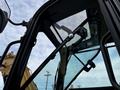 The image shows the interior view of a 2024 Caterpillar 306 cab focusing on the control panel and windshield wipers