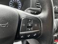 Close-up of a steering wheel with control buttons for navigation phone and menu functions from a 2020 Ford Transit