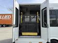 A 2010 Ford Econoline with an open rear door revealing a wheelchair lift inside the vehicle