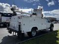 A 2016 Ford F-550 truck equipped with a utility body and an elevated work platform on the back