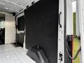 Interior of a 2022 Ford Transit cargo van with a black wall panel and a flat floor