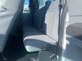 Interior view of a 2014 Ford F-250 SD showing the backseat with grey fabric upholstery and seatbelts