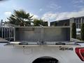 A 2021 Ford F-150 with a diamond plate tool box installed in the truck bed featuring two compartments for storage