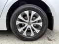 A close-up of a silver alloy wheel from a 2025 Toyota Corolla with a Yokohama tire showcasing intricate spokes and the Toyota logo in the center