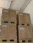 Stacked wooden crates with metal corner reinforcements arranged on wooden pallets