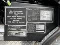 A metal panel displaying safety instructions and specifications for a 1991 Sutphen Deluge fire truck includes capacity and chassis information