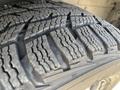 Close-up of a tire tread from a 2016 Ford Transit showing detailed patterns and grooves designed for traction and grip