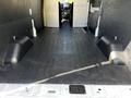 Interior of a 2022 Ford Transit cargo van featuring a spacious, empty floor with two black wheel wells visible