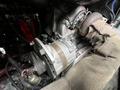 A view of the engine of a 1991 Sutphen Deluge featuring a turbocharger and various components including wires and hoses