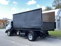 A 2009 Ford LCF 550 box truck with a black cargo bed and a white cab viewed from the rear side