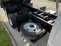 A 2021 Ford F-550 chassis with a partially visible spare tire mounted on its side