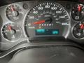 Dashboard of a 2016 Chevrolet Express displaying speedometer fuel gauge engine temperature gauge and a digital odometer reading 338735 miles with a temperature of 12 degrees Celsius