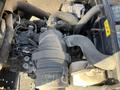 Close-up view of the engine compartment of a 2010 Kubota F3990 showing various components including hoses and the air intake system