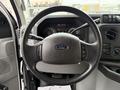 Steering wheel of a 2014 Ford Econoline with controls for audio and cruise settings
