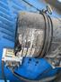 A close-up view of a dusty air filter from a 1997 Genie S-65 4X4 showing a partially torn label with manufacturer details and connected wires
