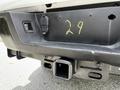 A close-up of the rear bumper of a 2017 Ford F-250 SD showing a tow hitch receiver and a small electrical connector with the number 29 written in yellow