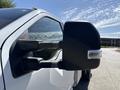 Close-up of the side mirror of a 2019 Ford F-550 showing the black casing and integrated turn signal