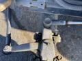 Close-up of a mechanical joint on a 2010 Kubota F3680 showcasing a shaft with a connecting rod and fittings attached