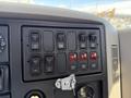 Control panel of a 2008 International 7500 featuring various switches and buttons for lights and engine functions