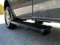 A 2017 Mercedes-Benz Sprinter with a black side step mounted below the door and a textured surface for grip