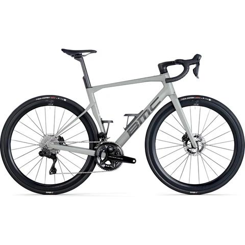 A 2026 BMC Roadmachine 01 TWO bicycle in light gray with a sleek frame disc brakes and black wheels designed for road cycling