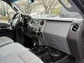 The interior of a 2016 Ford F-350 Super Duty featuring a dashboard with controls air vents and seating in gray fabric