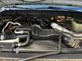 Close-up of the engine compartment of a 2016 Ford F-550 featuring various components like hoses wires and a large air intake assembly