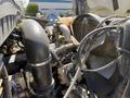 Close-up of the engine components of a 2009 International 7500 including pipes wires and the fan assembly