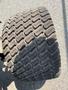 A close-up of a large, heavily treaded tire from a 2012 John Deere 1445 SERIES II 4WD vehicle