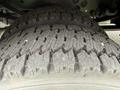 Close-up of a heavily treaded tire from a 2008 Ford F-450 SD showing significant wear patterns on the rubber surface