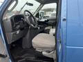 Interior of a 2006 Ford Econoline showing the driver's seat steering wheel and dashboard with controls