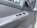 A close-up view of the interior door panel of a 2008 Mitsubishi Fuso FE180 featuring power window switches and textured gray surfaces