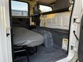 Interior view of a 2017 Isuzu NPR showing a single bench seat and the cabin area with a simple gray fabric upholstery and metal surfaces