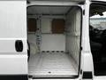 Interior view of a 2018 RAM Promaster showing an empty cargo space with white walls and a metal floor