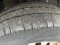 A close-up of a worn tire from a 2023 Ford Transit showing tread depth and surface wear