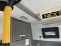 Interior view of a 2018 Chevrolet Express showing the ceiling, light fixture, and yellow handrail