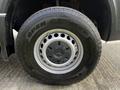 Close-up of a tire mounted on a 2017 Mercedes-Benz Sprinter featuring a silver wheel rim and an open country tread pattern