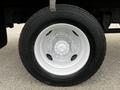 A close-up of a tire and wheel from a 2006 Hino 268 showcasing a silver rim and black tire with tread patterns and the Hino logo visible on the wheel