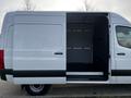 A 2022 Mercedes-Benz Sprinter with an open sliding door revealing a spacious interior designed for cargo transport