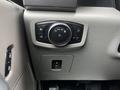 A control panel in a 2017 Ford F-150 featuring various buttons for lights and functions including a round dial and a toggle switch