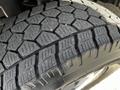 A close-up of a tread pattern on a tire from a 2017 Mercedes-Benz Sprinter showing deep grooves and a rugged design for traction